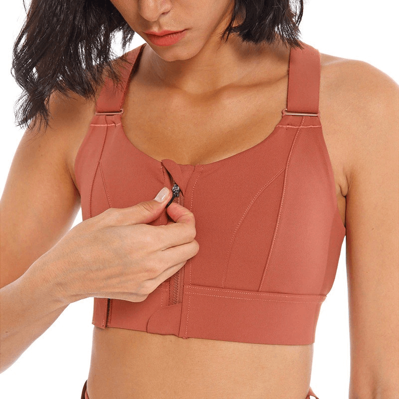 Woman wearing a stylish rust shockproof sports bra with adjustable front fastening, designed for comfort and flexibility during workouts.